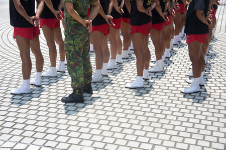 Soldiers lined up in camouflage/Soldiers in army uniform line up holding gunsの写真素材