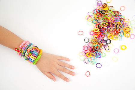 Little girl wearing colorful loom band rubber braceletの写真素材