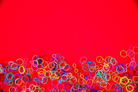 Little girl wearing colorful loom band rubber braceletの写真素材