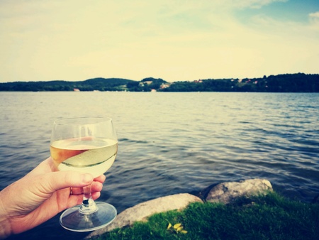 Time to relax on the Chmielno lake with a glass of delicious dry white wine.の素材