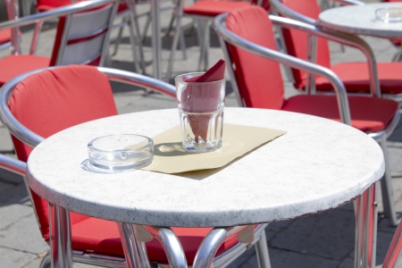 Empty tables of sidewalk cafe in Italiaの写真素材