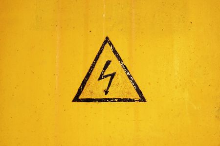 high voltage sign on ragged backgroundの写真素材