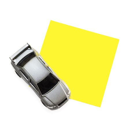 clean post-it note on a white background with a car toy at the left cornerの写真素材
