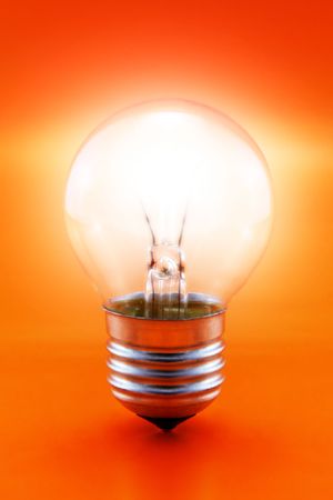 close-up of a glowing light bulb on a red background