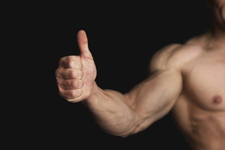 Strong Athletic Man Showing Big Thumbの写真素材