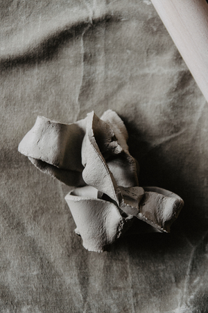 A piece of clay on table. Handmade craft backgroundの写真素材