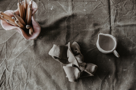A piece of clay on table. Handmade craft background