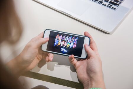Los Angeles, California, USA - 25 February 2019: Hands holding a smartphone with Vainglory MOBA game...