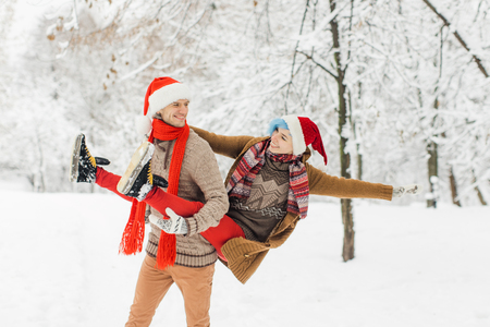 couple in love walking in the snowy forestの写真素材