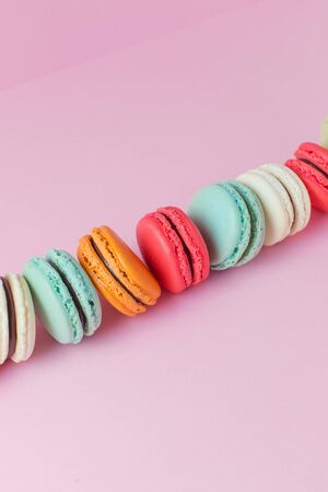 Beautiful colorful desserts. French macaroons on a pink backgroundの写真素材
