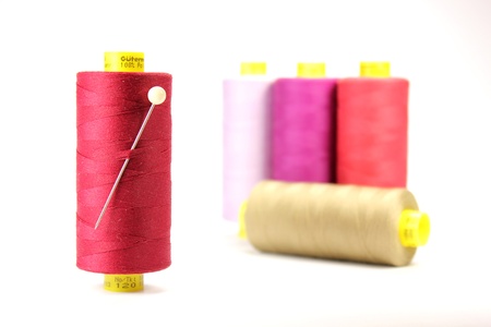 Close up shot of spool with cotton thread and needleの写真素材