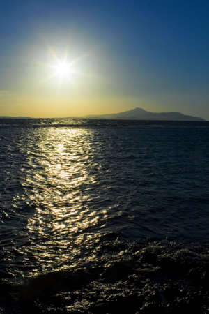 The sun, the sea and mountains in the early morningの写真素材