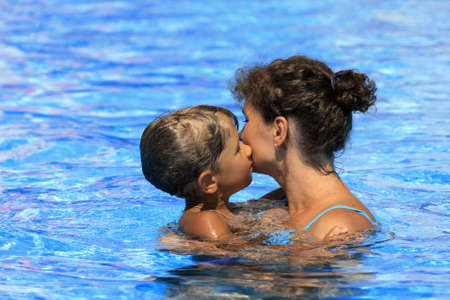 Mother and the son float in poolの写真素材
