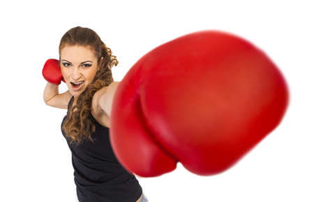 The aggressive girl in boxing gloves strikes blow