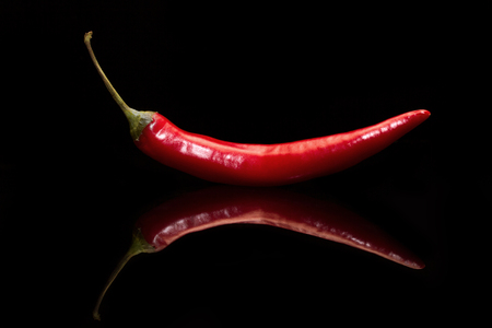 Red pepper on a black background. Side viewの写真素材