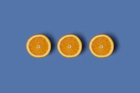 Three cut oranges in a row