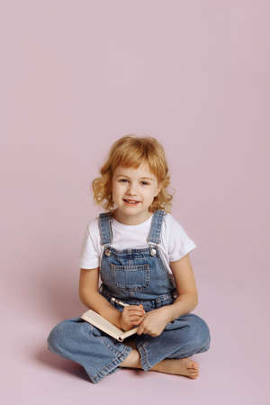 Cute long haired girl in denim overalls.