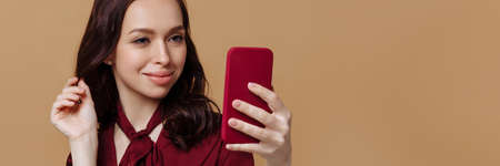 Banner beautiful young woman in red on a brown background.