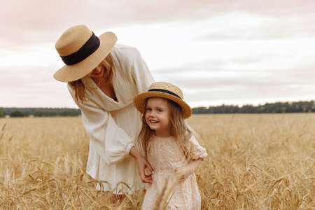 Mom and daughter in a wheat fieldの写真素材