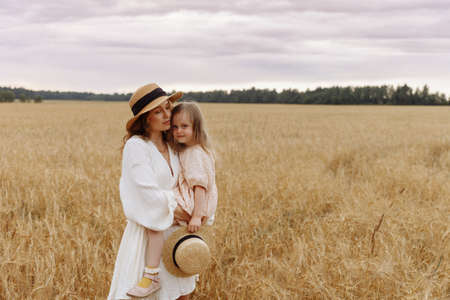 Mom and daughter in a wheat fieldの写真素材