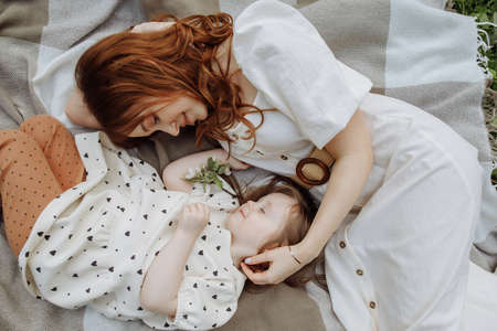 Mom and daughter lying side by sideの写真素材