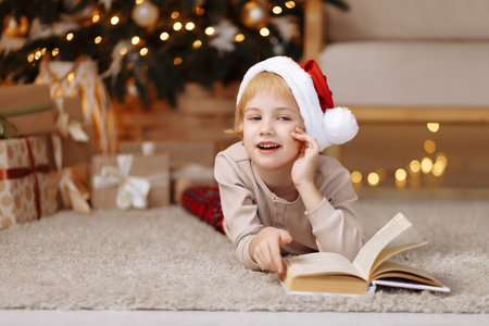 Girl lies on the floor and reads a bookの写真素材