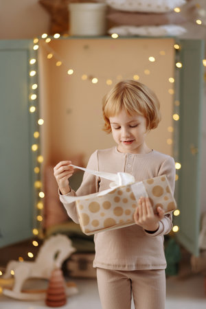 Girl stands with a gift in her handsの写真素材
