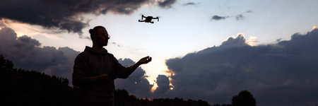 Banner man controlling a drone with a remote controlの写真素材