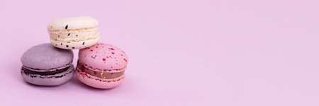 Banner sweet colorful macarons isolated on pink background.の写真素材