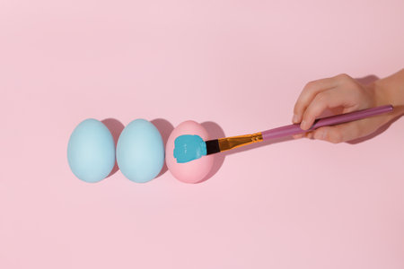 Three colored eggs in a row flat layer.の写真素材