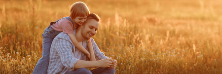 Little daughter hugging her father from behindの写真素材