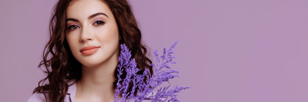 Attractive woman with bouquet on lilac backgroundの写真素材