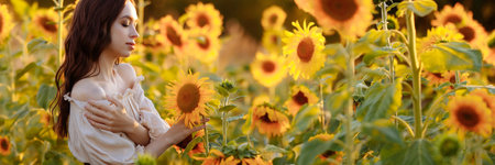 Banner beautiful woman in a dress in a field of sunflowersの写真素材