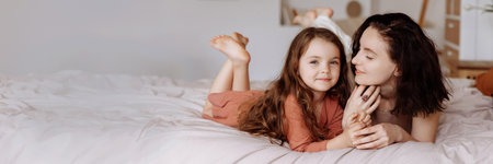 Mother and her daughter child girl playing and hugging. Happy loving family.の写真素材