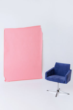 Blue armchair and pink backdrop in studio