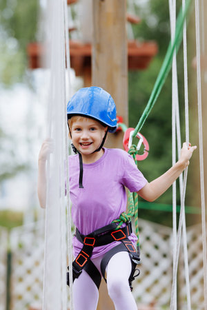 Child on ropes course with helmet and harnessの写真素材
