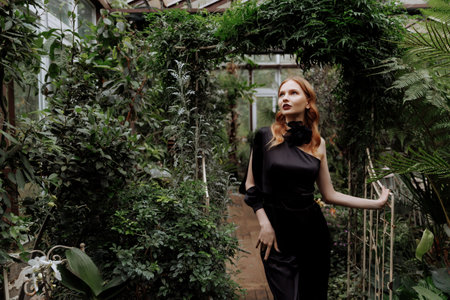 A woman walking through a greenhouse.の写真素材