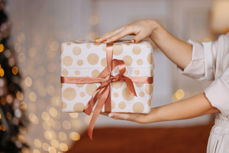 Gift in the hands of a woman for Christmas