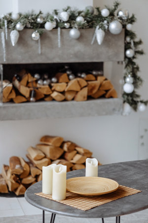 Cozy indoor setting, candles, gifts, firewood.の写真素材