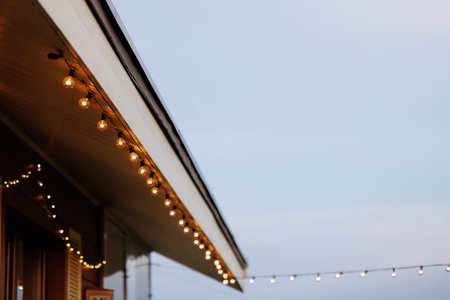Roof of a wooden one-story house with garlandの写真素材