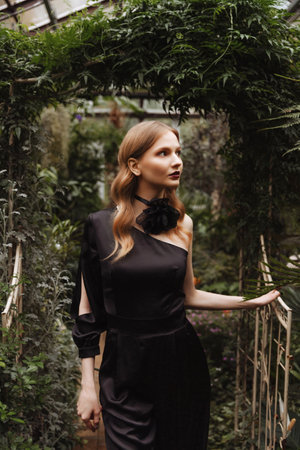 A woman walking through a greenhouse.の写真素材