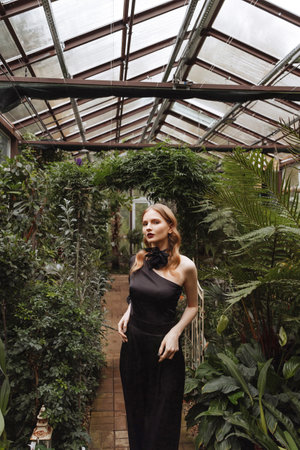A woman walking through a greenhouse.の写真素材