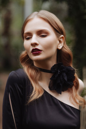 Portraint woman with wavy hair, dark attire.の写真素材