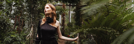 Banner woman walking through a greenhouse.