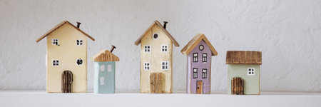 Banner wooden miniature houses on white shelf.