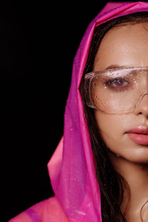 Woman wearing pink raincoat and large clear garden or safety glassesの写真素材