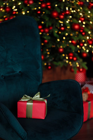 A green chair with a one red gift box on itの写真素材