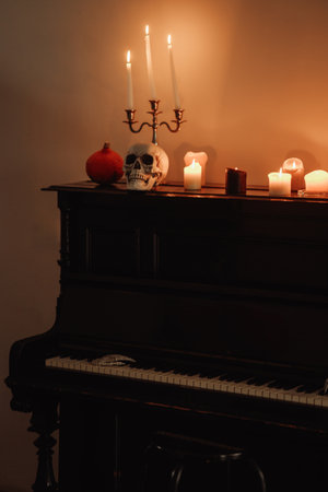 Piano with skull and candles on it. Halloween decorations from pumpkin.の写真素材