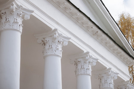 Close-up of white columns of a building with a classical design.