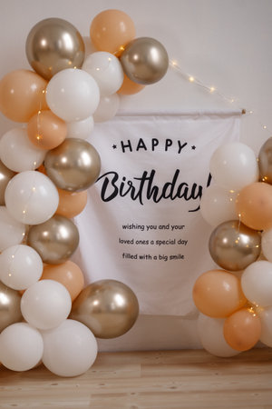 A banner with balloons and the words Happy Birthday written on itの写真素材